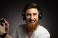 Young handsome gamer man playing video game using joystick and headphones with happy face smiling Royalty Free Stock Photo