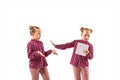 Young handsome girl arguing with herself on white studio background.