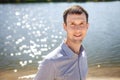 Young guy resting near lake Royalty Free Stock Photo
