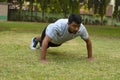 Young guy doing push ups in a park