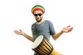 Young handsome guy learns to play the djembe drum instrument on a white background Royalty Free Stock Photo