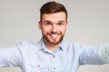 Young handsome guy making selfie against beige background Royalty Free Stock Photo