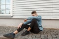 Young handsome guy model in a fashionable denim vintage jacket