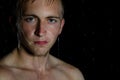 Young handsome guy in shower. Water, cleanliness and freshness Royalty Free Stock Photo