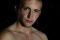 Young handsome guy in shower. Water, cleanliness and freshness Royalty Free Stock Photo