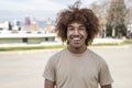 Young handsome guy smiling relaxed and looking at camera in the street. Confident happy man laughing and staring at Royalty Free Stock Photo