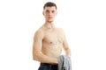 Young handsome guy stands with the Bared torso holding a Mike and looks into a camera Royalty Free Stock Photo