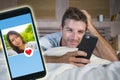 Young handsome and happy man using internet social media on mobile phone searching love flirting and dating online sending like to Royalty Free Stock Photo