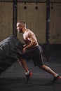 Young handsome healthy man performing exercise with tractor tire Royalty Free Stock Photo