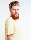 young handsome hipster ginger bearded guy looking brutal isolated on white background, lifestyle people concept Royalty Free Stock Photo
