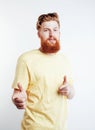 Young handsome hipster ginger bearded guy looking brutal isolated on white background, lifestyle people concept Royalty Free Stock Photo