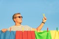 Young handsome hipster man hanging laundry with clothespin