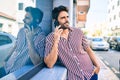 Young handsome hispanic man with beard smiling happy outdoors speaking on the phone Royalty Free Stock Photo