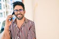 Young handsome hispanic man with beard smiling happy outdoors speaking on the phone Royalty Free Stock Photo