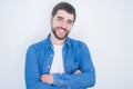 Young handsome hispanic man smiling at the camera with arms crossed looking happy and confident over isolated white background Royalty Free Stock Photo