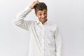Young handsome hispanic man standing over isolated background confuse and wonder about question Royalty Free Stock Photo
