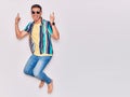 Young handsome hispanic man wearing casual clothes and sunglasses smiling happy Royalty Free Stock Photo