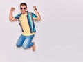 Young handsome hispanic man wearing casual clothes and sunglasses smiling happy Royalty Free Stock Photo