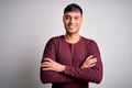 Young handsome hispanic man wearing casual shirt standing over white isolated background happy face smiling with crossed arms Royalty Free Stock Photo