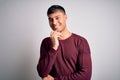 Young handsome hispanic man wearing casual shirt standing over white isolated background looking confident at the camera with Royalty Free Stock Photo