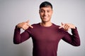 Young handsome hispanic man wearing casual shirt standing over white isolated background looking confident with smile on face, Royalty Free Stock Photo