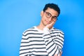 Young handsome hispanic man wearing casual sweater and glasses thinking looking tired and bored with depression problems with Royalty Free Stock Photo