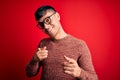 Young handsome hispanic man wearing nerd glasses over red background pointing fingers to camera with happy and funny face Royalty Free Stock Photo