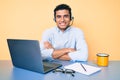 Young handsome hispanic man working at the office wearing operator headset happy face smiling with crossed arms looking at the Royalty Free Stock Photo