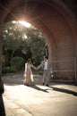 Young handsome Indian couple walking through brick archway Royalty Free Stock Photo