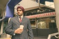 Young handsome Indian Sikh businessman wearing turban while exploring the city Royalty Free Stock Photo