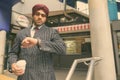 Young handsome Indian Sikh businessman wearing turban while exploring the city Royalty Free Stock Photo