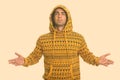 Young handsome Iranian man wearing hoodie raising both arms Royalty Free Stock Photo