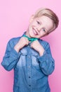 Young handsome kid smiling with blue shirt and butterfly tie. Studio portrait over pink background Royalty Free Stock Photo