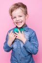 Young handsome kid smiling with blue shirt and butterfly tie. Studio portrait over pink background Royalty Free Stock Photo