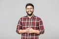 Young handsome male with beard against gray background Royalty Free Stock Photo