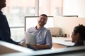 Millennial happy male businessman laughing with colleagues. Royalty Free Stock Photo