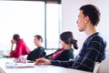 Young, handsome male college student sitting in a classroom Royalty Free Stock Photo