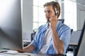 Young handsome male customer support phone operator with headset working in call center Royalty Free Stock Photo