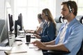 Young handsome male customer support phone operator with headset working in call center Royalty Free Stock Photo