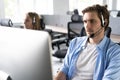 Young handsome male customer support phone operator with headset working in call center Royalty Free Stock Photo