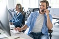 Young handsome male customer support phone operator with headset working in call center Royalty Free Stock Photo