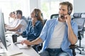 Young handsome male customer support phone operator with headset working in call center Royalty Free Stock Photo