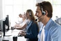 Young handsome male customer support phone operator with headset working in call center Royalty Free Stock Photo