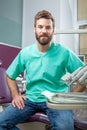 Young handsome male doctor with beard smiling with white teeth Royalty Free Stock Photo