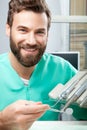 Young handsome male doctor smiling with dental mirror in hands Royalty Free Stock Photo