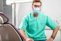 Young handsome male doctor wearing dentist mask and glasses. Royalty Free Stock Photo