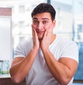 Young handsome man applying face cream Royalty Free Stock Photo