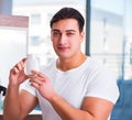 Young handsome man applying face cream Royalty Free Stock Photo