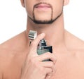 Young handsome man applying perfume Royalty Free Stock Photo