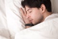 Young handsome man is asleep and wristband tracking his sleep Royalty Free Stock Photo